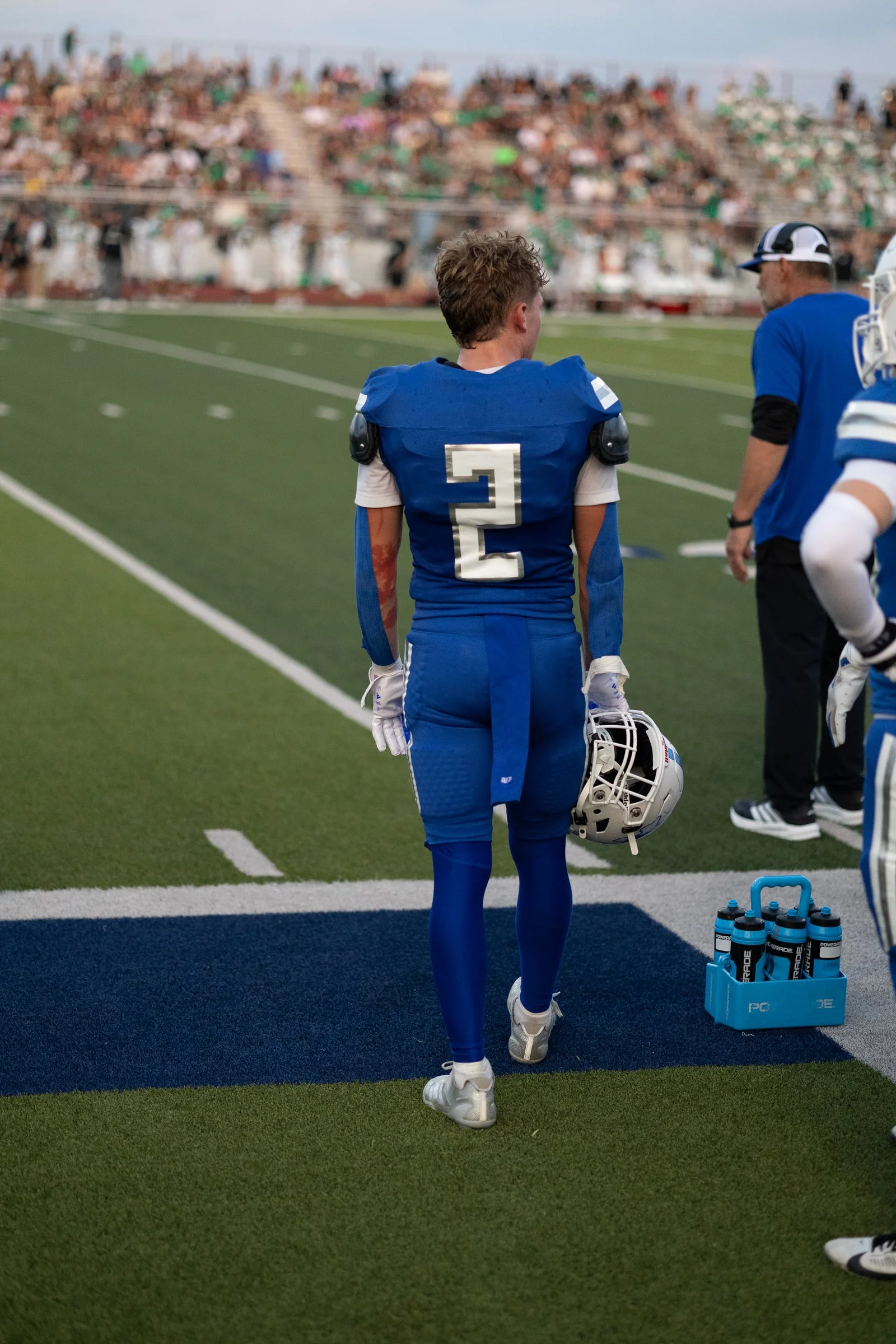 Number 2 from behind on the sideline, helmet in hand, straight off the camera